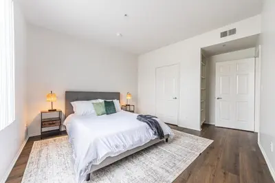 a white bedroom with a bed and a rug at 3BR Marina del Rey Condo with Pool, Hot Tub & Parking - 15 Min to LAX in Los Angeles