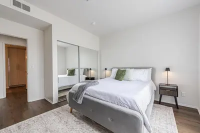 a white bedroom with a large bed and a mirror at 3BR Marina del Rey Condo with Pool, Hot Tub & Parking - 15 Min to LAX in Los Angeles
