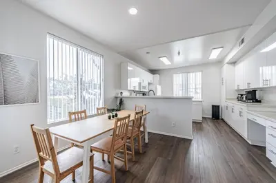 a kitchen and dining room with a table and chairs at 3BR Marina del Rey Condo with Pool, Hot Tub & Parking - 15 Min to LAX in Los Angeles