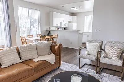 a living room and kitchen with a couch and chairs at 3BR Marina del Rey Condo with Pool, Hot Tub & Parking - 15 Min to LAX in Los Angeles