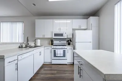 a kitchen with white cabinets and white appliances at 3BR Marina del Rey Condo with Pool, Hot Tub & Parking - 15 Min to LAX in Los Angeles