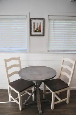 a table and two chairs with a table and two windows at Champagne Retreat in Upland