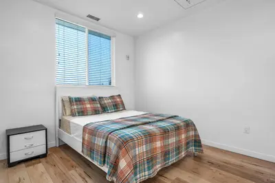a white bedroom with a bed and a window at Chic 1 Bedroom Loft with Balcony Hollywood Sign View Free Gated Parking Full Kitchen in Los Angeles