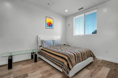 a bedroom with a bed and a window at Stylish 1 Bedroom Loft in Hollywood Balcony Free Gated Parking In Unit Laundry in Los Angeles