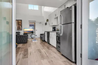 a kitchen with a stainless steel refrigerator at Stylish 1 Bedroom Loft in Hollywood Balcony Free Gated Parking In Unit Laundry in Los Angeles