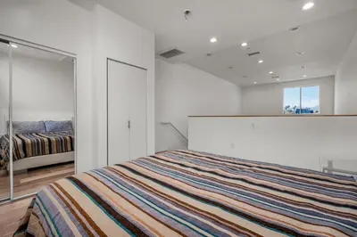 a white bedroom with a bed and a window at Stylish 1 Bedroom Loft in Hollywood Balcony Free Gated Parking In Unit Laundry in Los Angeles