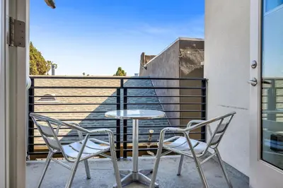 a patio with two chairs and a table on a balcony at Koreatown Hollywood Urban Oasis 1 Bedroom Loft with Private Parking and Balcony in Los Angeles