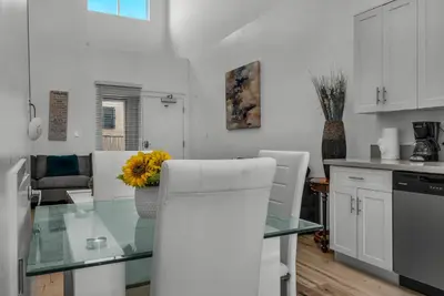 a kitchen with a glass table with a flower in a vase at Koreatown Hollywood Urban Oasis 1 Bedroom Loft with Private Parking and Balcony in Los Angeles