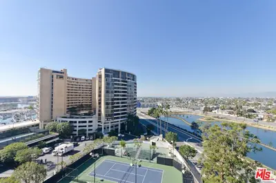 a tennis court in front of a city with buildings at A Stunning Luxury Resort-Style Furnished Condominium Plus All Inclusive Amenities! in Los Angeles