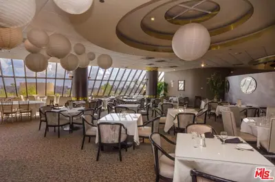 a restaurant with white tables and chairs and lights at A Stunning Luxury Resort-Style Furnished Condominium Plus All Inclusive Amenities! in Los Angeles