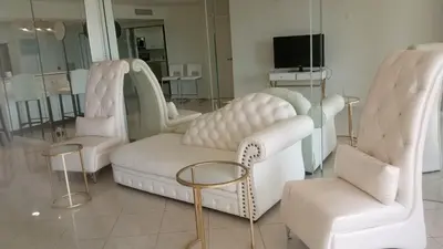a room with two white chairs and a tv at A Stunning Luxury Resort-Style Furnished Condominium Plus All Inclusive Amenities! in Los Angeles