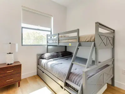 a bedroom with two bunk beds and a window at Modern Luxe Retreat Three-Bedroom #4 in Los Angeles