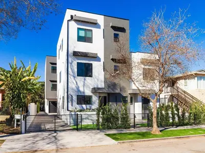 a white building with a tree in front of it at Modern Luxe Retreat Three-Bedroom #4 in Los Angeles