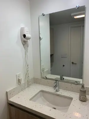 a bathroom with a sink and a large mirror at Western Romaine in Los Angeles
