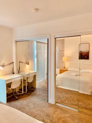 a hotel room with a bed and a desk and a bed at Western Romaine in Los Angeles