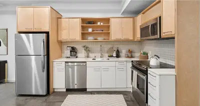 a kitchen with white appliances and wooden cabinets at Loft & Luxe Hollywood with FREE PARKING in Los Angeles