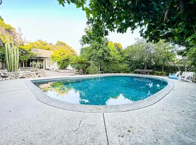 a swimming pool in the middle of a yard at Relaxed and Cozy Poolside Studio - LOU2 - BUR in Burbank