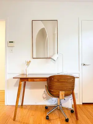 a wooden desk with a chair and a mirror at 6BR Pool Escape for Friends and Family - LOU1 - BUR in Burbank