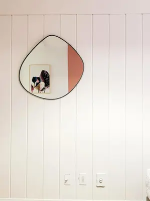 a mirror hanging on a wall in a bathroom at 6BR Pool Escape for Friends and Family - LOU1 - BUR in Burbank