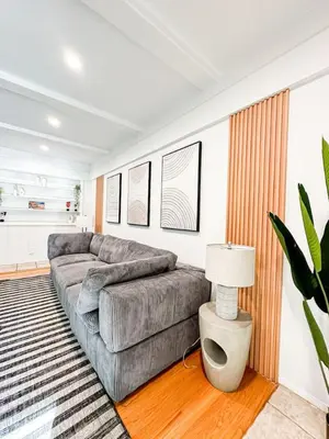 a living room with a couch and a table at 6BR Pool Escape for Friends and Family - LOU1 - BUR in Burbank
