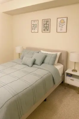 a bedroom with a large bed with two lamps at LA Koreatown Nest House - Modern, Free Parking, Pool and Sauna, No Cleaning Fee in Los Angeles