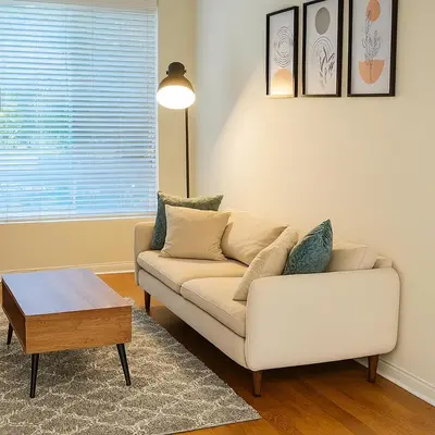 a living room with a couch and a coffee table at LA Koreatown Nest House - Modern, Free Parking, Pool and Sauna, No Cleaning Fee in Los Angeles