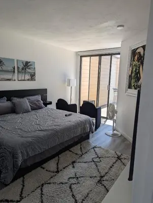 a bedroom with a bed and a large window at 31 night required rental Waterfront penthouse 180 ocean view in Redondo Beach