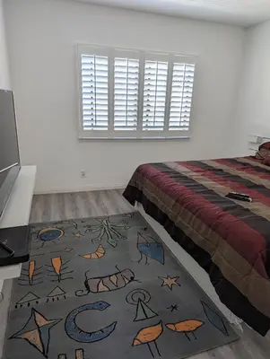 a bedroom with a bed and a rug on the floor at 31 night required rental Waterfront penthouse 180 ocean view in Redondo Beach