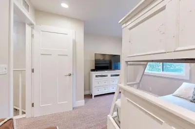 a bedroom with a bunk bed and a tv at On the Doorstep in Anaheim