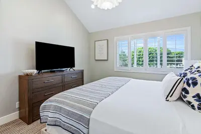 a bedroom with a bed and a flat screen tv at Mickey's Corner in Anaheim