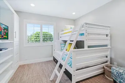 a white bunk bed in a room with a window at Mickey's Corner in Anaheim