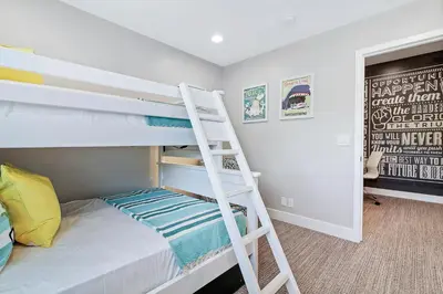 a bedroom with a bunk bed with a ladder at Mickey's Corner in Anaheim