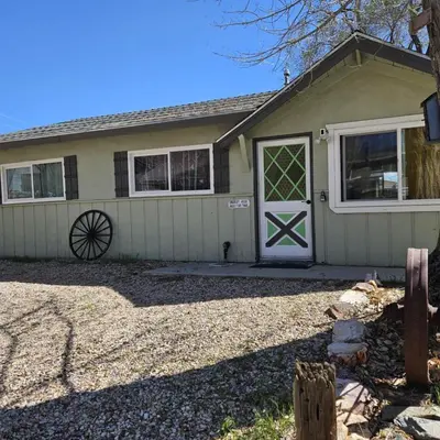 a house with a white door and windows at Cozy Mountain Retreat in Frazier Park