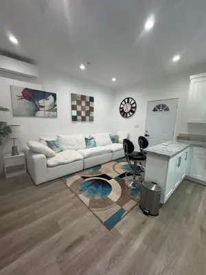 a white living room with a couch and a table at Stunning Guest House in West Hills California in Hughes-Canoga Park Heliport