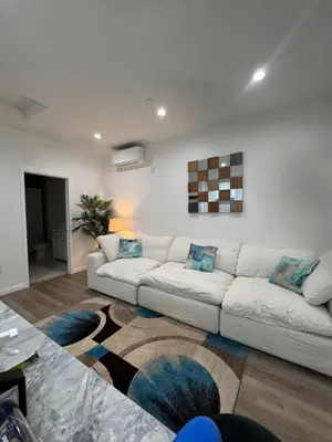 a living room with a white couch and a rug at Stunning Guest House in West Hills California in Hughes-Canoga Park Heliport