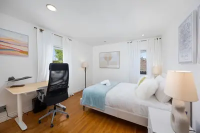 a bedroom with a bed and a desk and a computer at The Luxe Escape | Near LAX & West LA Hotspots in Los Angeles