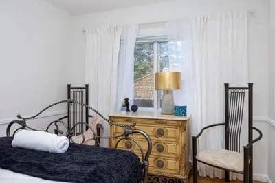 a bedroom with a bed and two chairs and a window at The Luxe Escape | Near LAX & West LA Hotspots in Los Angeles