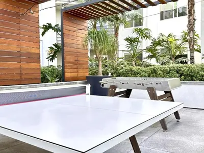 a white ping pong table on a patio at Tangerine Terrace -10 min to Disney&Angel Stadium in Orange