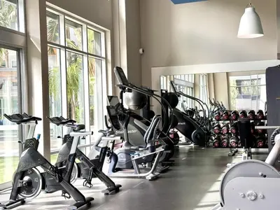 a gym with a bunch of treadmills and machines at Tangerine Terrace -10 min to Disney&Angel Stadium in Orange