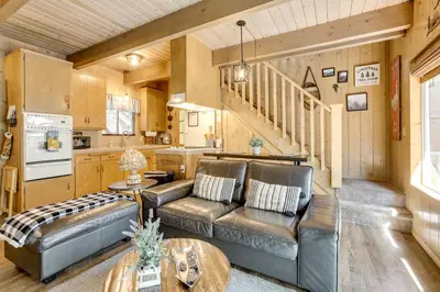 a living room with a couch and a table at 2 Mi to Lake Arrowhead Pet-Friendly Cabin in Lake Arrowhead