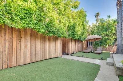 a backyard with a fence and a chair and a gazebo at 4 Mi to Beverly Hills Quiet LA Gem with Shared Yard in Los Angeles