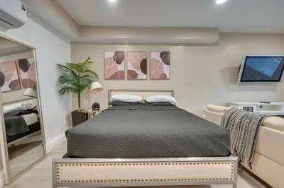 a bedroom with a bed and a flat screen tv at 4 Mi to Hollywood Mid-Wilshire Couples Retreat in Los Angeles