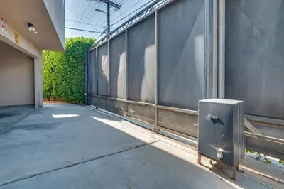 a metal trash can sitting on the side of a building at 4 Mi to Hollywood Mid-Wilshire Couples Retreat in Los Angeles
