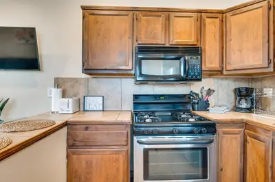 a kitchen with a stove and a microwave at 9 Mi to Airport WFH-Friendly Apt in Los Angeles! in Los Angeles