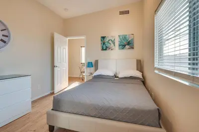 a bedroom with a bed and a clock on the wall at 9 Mi to Airport WFH-Friendly Apt in Los Angeles! in Los Angeles