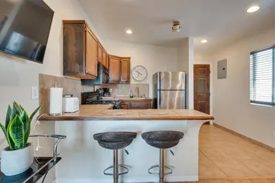 a kitchen with a counter and two bar stools at 9 Mi to Airport WFH-Friendly Apt in Los Angeles! in Los Angeles