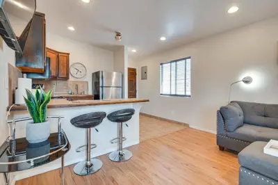 a kitchen and living room with a counter and a couch at 9 Mi to Airport WFH-Friendly Apt in Los Angeles! in Los Angeles