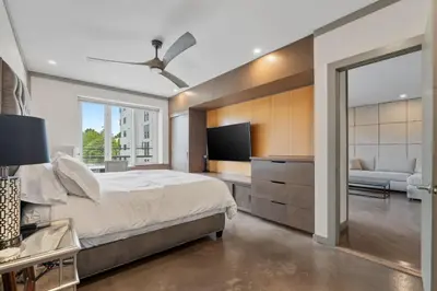 a bedroom with a bed and a tv and a couch at Stylish Westwood Condo, Near UCLA & Century City in Los Angeles