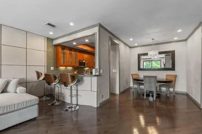 a kitchen and living room with a table and a couch at Stylish Westwood Condo, Near UCLA & Century City in Los Angeles