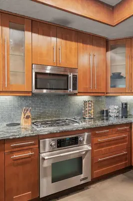a kitchen with a stainless steel oven and microwave at Stylish Westwood Condo, Near UCLA & Century City in Los Angeles